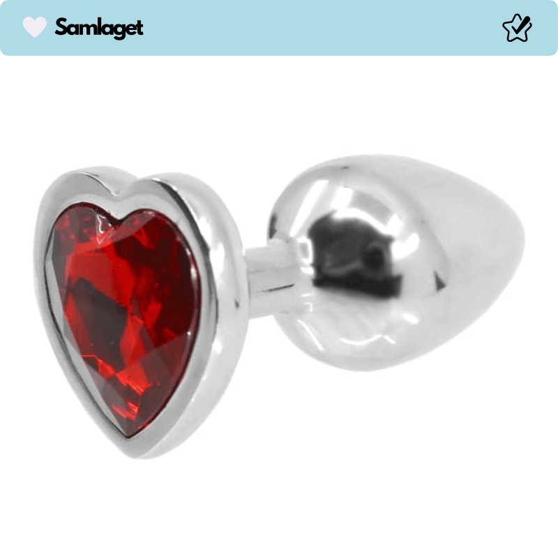Lust Love Plug i metall med hjärtformad bas dekorerad med en röd ädelsten.
